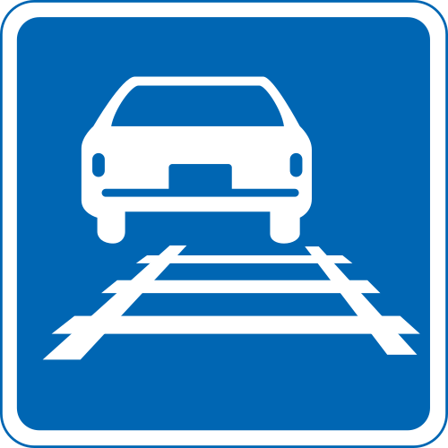 Blue circular sign showing a car above tram tracks (軌道敷内通行可).